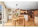 Dining area open to the kitchen with natural light, wooden table and seating, and hardwood floors at 6190 Sparrow Ave, Firestone, CO 80504
