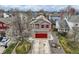 A charming two-story house features a red garage door, complementary red shutters, and lovely landscaping at 6190 Sparrow Ave, Firestone, CO 80504