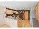 Functional kitchen featuring wood cabinets, a breakfast bar area, and stainless steel appliances at 6190 Sparrow Ave, Firestone, CO 80504
