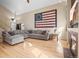 Open living room with vaulted ceilings, and a sizable gray sectional sofa at 6190 Sparrow Ave, Firestone, CO 80504