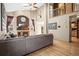 Inviting living room with vaulted ceiling, large windows, a fireplace, and an oversized gray sectional sofa at 6190 Sparrow Ave, Firestone, CO 80504