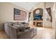Comfortable living room featuring vaulted ceilings, large windows, and a cozy fireplace at 6190 Sparrow Ave, Firestone, CO 80504