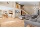 Open concept living room with hardwood floors, vaulted ceilings, and access to dining area and kitchen at 6190 Sparrow Ave, Firestone, CO 80504
