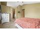 Bedroom featuring carpet, ensuite bathroom, ample closet space, and bright windows at 6190 Sparrow Ave, Firestone, CO 80504