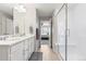 Bright bathroom featuring a double vanity, spacious shower with glass enclosure, and modern fixtures at 74 Lullaby Ln, Castle Rock, CO 80109