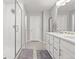 Bright bathroom featuring a double vanity, spacious shower with glass enclosure, and modern fixtures at 74 Lullaby Ln, Castle Rock, CO 80109