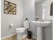 Cozy powder room featuring a pedestal sink, neutral decor, and stylish accessories at 74 Lullaby Ln, Castle Rock, CO 80109