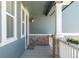 Inviting covered front porch with classic white railings and stone accents at 74 Lullaby Ln, Castle Rock, CO 80109
