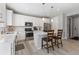 Modern kitchen with white cabinets, stainless steel appliances, and a central island at 74 Lullaby Ln, Castle Rock, CO 80109