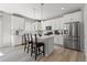 Beautiful kitchen boasts stainless steel appliances, white cabinets, a stylish backsplash, and a large center island at 74 Lullaby Ln, Castle Rock, CO 80109