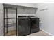 Well-organized laundry room with modern appliances, shelving, and ample space for storage at 74 Lullaby Ln, Castle Rock, CO 80109