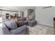 Comfortable gray sectional sofa in a well-lit living room adjacent to the kitchen at 74 Lullaby Ln, Castle Rock, CO 80109