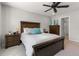 Comfortable main bedroom with wood furnishings, ceiling fan, and ensuite bathroom at 74 Lullaby Ln, Castle Rock, CO 80109