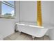 Clawfoot bathtub providing a vintage touch with a window view at 3132 Umatilla St # B, Denver, CO 80211