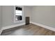 Bedroom with a view to the outdoor balcony and restored cast iron radiator at 3132 Umatilla St # B, Denver, CO 80211