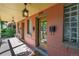 Inviting front porch featuring updated lighting, a glass block window, and access to the front door at 3132 Umatilla St # B, Denver, CO 80211