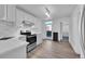 Bright, updated kitchen with stainless steel appliances and light-colored hardwood flooring at 3132 Umatilla St # B, Denver, CO 80211