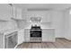 Well-lit kitchen with white cabinets, stainless steel appliances, and modern finishes at 3132 Umatilla St # B, Denver, CO 80211