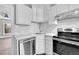 Modern kitchen featuring white countertops, subway tile backsplash, and stainless steel appliances at 3132 Umatilla St # B, Denver, CO 80211