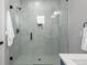 Bright shower with white marble with black fixtures, inset storage, and modern glass at 1248 Josephine St # 2, Denver, CO 80206