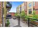 Apartment balcony overlooking a charming courtyard with greenery and parking at 2325 Walnut St # 4, Denver, CO 80205