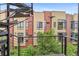 Apartment view overlooking the balcony with metal railings and lush trees in a well-maintained area at 2325 Walnut St # 4, Denver, CO 80205