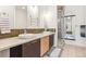 Bathroom featuring double sinks, glass-enclosed shower, and modern tile at 2325 Walnut St # 4, Denver, CO 80205