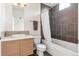 Bathroom featuring dark tile work, a soaking tub, and a stylish vanity with a sink and modern fixtures at 2325 Walnut St # 4, Denver, CO 80205