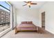 Bedroom with a large window and a ceiling fan plus carpet at 2325 Walnut St # 4, Denver, CO 80205