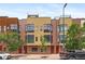 Contemporary townhome featuring a brick facade, large windows, and a rooftop deck at 2325 Walnut St # 4, Denver, CO 80205