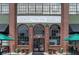 The exterior view of the Denver Central Market with plants and chairs outside at 2325 Walnut St # 4, Denver, CO 80205
