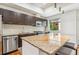 Modern kitchen featuring a granite-topped island, dark cabinets, and stainless steel appliances at 2325 Walnut St # 4, Denver, CO 80205