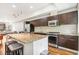 Modern kitchen with stainless steel appliances, granite counters, and wood floors at 2325 Walnut St # 4, Denver, CO 80205