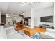 Spacious living room with fireplace, hardwood floors, and stairs leading to kitchen and upper floors at 2325 Walnut St # 4, Denver, CO 80205