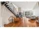 Open floor plan boasts a modern staircase, fireplace, and large windows with neighborhood views at 2325 Walnut St # 4, Denver, CO 80205