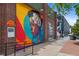 A colorful mural on the side of a brick building with the doors visible at 2325 Walnut St # 4, Denver, CO 80205