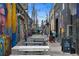 A street view with people walking and several outdoor seating with umbrellas at 2325 Walnut St # 4, Denver, CO 80205