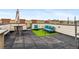 Relax in the rooftop deck seating area with artificial turf, a table, and plenty of space to entertain guests at 2325 Walnut St # 4, Denver, CO 80205