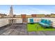 Enjoy the rooftop deck seating area with artificial turf and plenty of space to entertain guests and relax at 2325 Walnut St # 4, Denver, CO 80205