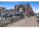 A street view with murals on the side of buildings and parked cars on the road at 2325 Walnut St # 4, Denver, CO 80205