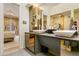 Modern bathroom featuring double sinks, a sleek vanity, a lighted mirror, and a glass-enclosed shower at 999 N Emerson St # 9, Denver, CO 80218