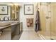 Contemporary bathroom with dual sinks, sleek vanity, large mirror and glass enclosed shower with modern fixtures at 999 N Emerson St # 9, Denver, CO 80218