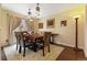 Elegant dining room featuring ornate light fixtures and a wooden dining table set for six at 999 N Emerson St # 9, Denver, CO 80218