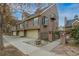 Townhomes with attached garages and gated entry; manicured front yard landscaping and mature trees at 999 N Emerson St # 9, Denver, CO 80218