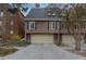 Stylish exterior featuring a private garage, complementary shutters, and mature landscaping at 999 N Emerson St # 9, Denver, CO 80218