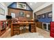 Inviting home office featuring a brick accent wall, custom built-ins, and a large wooden executive desk with a plush rug at 999 N Emerson St # 9, Denver, CO 80218