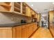 Well-lit kitchen featuring wood cabinets, granite countertops, and modern appliances at 999 N Emerson St # 9, Denver, CO 80218