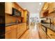 Contemporary kitchen with wooden cabinets, black countertops, and stainless steel appliances at 999 N Emerson St # 9, Denver, CO 80218