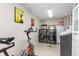 Efficient laundry area with modern washer and dryer, complemented by storage, and exercise equipment at 999 N Emerson St # 9, Denver, CO 80218