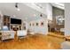 Open-concept living room with hardwood floors, a fireplace, a flatscreen TV, and easy access to the kitchen at 999 N Emerson St # 9, Denver, CO 80218